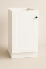 Base single door cabinet in white finish, featuring a minimalist design and black knob, suitable for kitchen cabinetry.